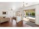 Open-concept living room with access to the outdoor pool area, hardwood floors and a ceiling fan at 2829 Via Florentine St, Henderson, NV 89074