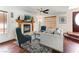 Comfortable living room with fireplace, wood floors, ceiling fan and large windows at 2829 Via Florentine St, Henderson, NV 89074