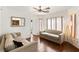Cozy living room featuring hardwood floors, two sofas, and natural light from large windows at 2829 Via Florentine St, Henderson, NV 89074
