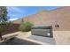 Relaxing backyard featuring a hot tub, decorative rock, and paved patio area at 2924 Sunday Silence Rd, North Las Vegas, NV 89086