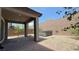 Covered backyard patio with hot tub, decorative rock, pavers, and lush greenery at 2924 Sunday Silence Rd, North Las Vegas, NV 89086