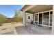 Covered backyard patio with pavers, hot tub, decorative rock, and sliding glass doors at 2924 Sunday Silence Rd, North Las Vegas, NV 89086