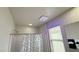Bathroom featuring a shower/tub combo with modern light fixture and vanity with a window at 2924 Sunday Silence Rd, North Las Vegas, NV 89086