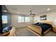 Spacious bedroom with a ceiling fan, comfortable bed, and abundant natural light at 2924 Sunday Silence Rd, North Las Vegas, NV 89086