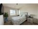 Relaxing bedroom with a decorative bed, bedside tables and lamps, and a large window at 2924 Sunday Silence Rd, North Las Vegas, NV 89086