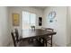 Cozy dining area with a modern table set, decorative wall art, and natural light at 2924 Sunday Silence Rd, North Las Vegas, NV 89086