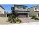 Two story home with brick driveway, two car garage and landscaped yard at 2924 Sunday Silence Rd, North Las Vegas, NV 89086