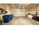 A clean two car garage with white walls, shelving, and space for storage at 2924 Sunday Silence Rd, North Las Vegas, NV 89086