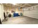 Spacious two car garage with overhead lighting, door to outside, and space for storage at 2924 Sunday Silence Rd, North Las Vegas, NV 89086