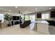 Open-concept living room featuring tile floors, a ceiling fan, and sliding glass doors at 2924 Sunday Silence Rd, North Las Vegas, NV 89086