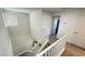 Carpeted staircase with white railings and a bright, open design at 2924 Sunday Silence Rd, North Las Vegas, NV 89086