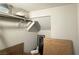 A cluttered storage closet space featuring a shelf, clothing rod and artwork at 2924 Sunday Silence Rd, North Las Vegas, NV 89086