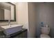 Modern bathroom features a vessel sink, sleek vanity, and contemporary fixtures and mosaic tiling at 3111 Bel Air Dr # 4B, Las Vegas, NV 89109
