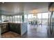 Dining area is open to the eat-in kitchen and includes a table, chairs, and floor-to-ceiling windows at 3111 Bel Air Dr # 4B, Las Vegas, NV 89109