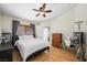 Bright bedroom with a ceiling fan, wood floors, and a comfortable bed at 3121 Fontana Colony Ct, North Las Vegas, NV 89031
