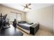 Bedroom featuring a ceiling fan, wooden floors, and a dedicated computer gaming area at 3121 Fontana Colony Ct, North Las Vegas, NV 89031