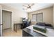 Well-lit bedroom features a ceiling fan, window, and space for a desk at 3121 Fontana Colony Ct, North Las Vegas, NV 89031