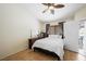 Bright bedroom with laminate flooring, a closet, and a ceiling fan at 3121 Fontana Colony Ct, North Las Vegas, NV 89031
