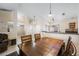 Open dining room with a wooden table and chairs, next to the living area and kitchen at 3121 Fontana Colony Ct, North Las Vegas, NV 89031