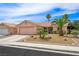 Charming single-story home with desert landscaping, mature palm trees and two-car garage at 3121 Fontana Colony Ct, North Las Vegas, NV 89031