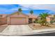 Charming single-story home with desert landscaping, mature palm trees and two-car garage at 3121 Fontana Colony Ct, North Las Vegas, NV 89031