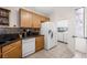 Well-lit kitchen with an adjacent laundry area, cabinets, and a tile backsplash at 3121 Fontana Colony Ct, North Las Vegas, NV 89031