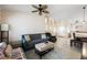 Open-concept living area featuring tile floors, neutral paint and comfortable seating at 3121 Fontana Colony Ct, North Las Vegas, NV 89031