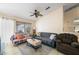 Comfortable living area featuring tile floors, neutral paint, ceiling fan and a sliding glass door at 3121 Fontana Colony Ct, North Las Vegas, NV 89031