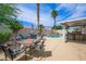 Outdoor dining and lounge area surrounding refreshing pool at 3121 Fontana Colony Ct, North Las Vegas, NV 89031