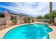 Beautiful pool area surrounded by desert landscaping and an outdoor kitchen at 3121 Fontana Colony Ct, North Las Vegas, NV 89031