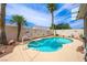 Inviting pool with rock landscaping and mature palm trees at 3121 Fontana Colony Ct, North Las Vegas, NV 89031