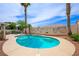 Sparkling pool with rock landscaping, palm trees and a mural at 3121 Fontana Colony Ct, North Las Vegas, NV 89031