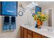 Nautical themed bathroom with double sinks, wood cabinets, and a decorative sailboat print at 3185 Mura Del Prato Ave, Henderson, NV 89044