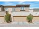 Well-maintained townhome featuring a two-car garage and lovely landscaping at 3185 Mura Del Prato Ave, Henderson, NV 89044