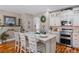 Bright and spacious kitchen featuring white cabinetry, stainless steel appliances, and a large island at 3185 Mura Del Prato Ave, Henderson, NV 89044