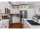 Bright kitchen featuring stainless steel appliances, marble countertops and white cabinets at 3185 Mura Del Prato Ave, Henderson, NV 89044