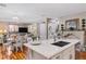 Open concept kitchen with island seating area, breakfast nook and adjacent living area at 3185 Mura Del Prato Ave, Henderson, NV 89044
