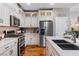 Modern kitchen with white cabinets, stainless steel appliances, and plenty of counter space at 3185 Mura Del Prato Ave, Henderson, NV 89044