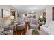Bright living room with hardwood floors, modern furniture, and an open layout connecting to the kitchen at 3185 Mura Del Prato Ave, Henderson, NV 89044