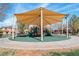 Community playground with colorful equipment and sunshade, providing a fun and safe play area for children at 3185 Mura Del Prato Ave, Henderson, NV 89044