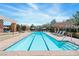 Relaxing community pool with lounge chairs, umbrellas, and well-maintained surroundings at 3185 Mura Del Prato Ave, Henderson, NV 89044