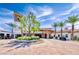 Mediterranean-style building with circular driveway, manicured landscaping, palm trees, and a welcoming entrance at 35 Via Rizzuto, Henderson, NV 89011