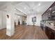 Spacious living room with bar and kitchen area, featuring wood floors and ample lighting at 35 Via Rizzuto, Henderson, NV 89011