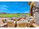 Inviting outdoor patio with comfortable seating around a modern fire pit and scenic views of a golf course at 35 Via Rizzuto, Henderson, NV 89011