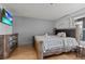 Cozy bedroom featuring a comfortable bed, wood floors and a flat-screen TV for relaxing evenings at 4200 S Valley View Blvd # 1007, Las Vegas, NV 89103