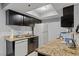 Functional kitchen with dark cabinetry, granite countertops, and bright overhead lighting at 4200 S Valley View Blvd # 1007, Las Vegas, NV 89103
