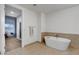 Bright bathroom featuring a contemporary soaking tub and tiled walls at 4525 Dean Martin Dr # 2109, Las Vegas, NV 89103