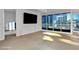 Bright, empty living room with city views from large windows at 4525 Dean Martin Dr # 2109, Las Vegas, NV 89103