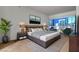 A spacious main bedroom boasts neutral decor, a modern platform bed, and expansive windows overlooking the city skyline at 4525 Dean Martin Dr # 2109, Las Vegas, NV 89103