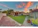 Spacious backyard featuring artificial turf, storage shed, and a covered patio at 4556 Kenilworth Ct, Las Vegas, NV 89147